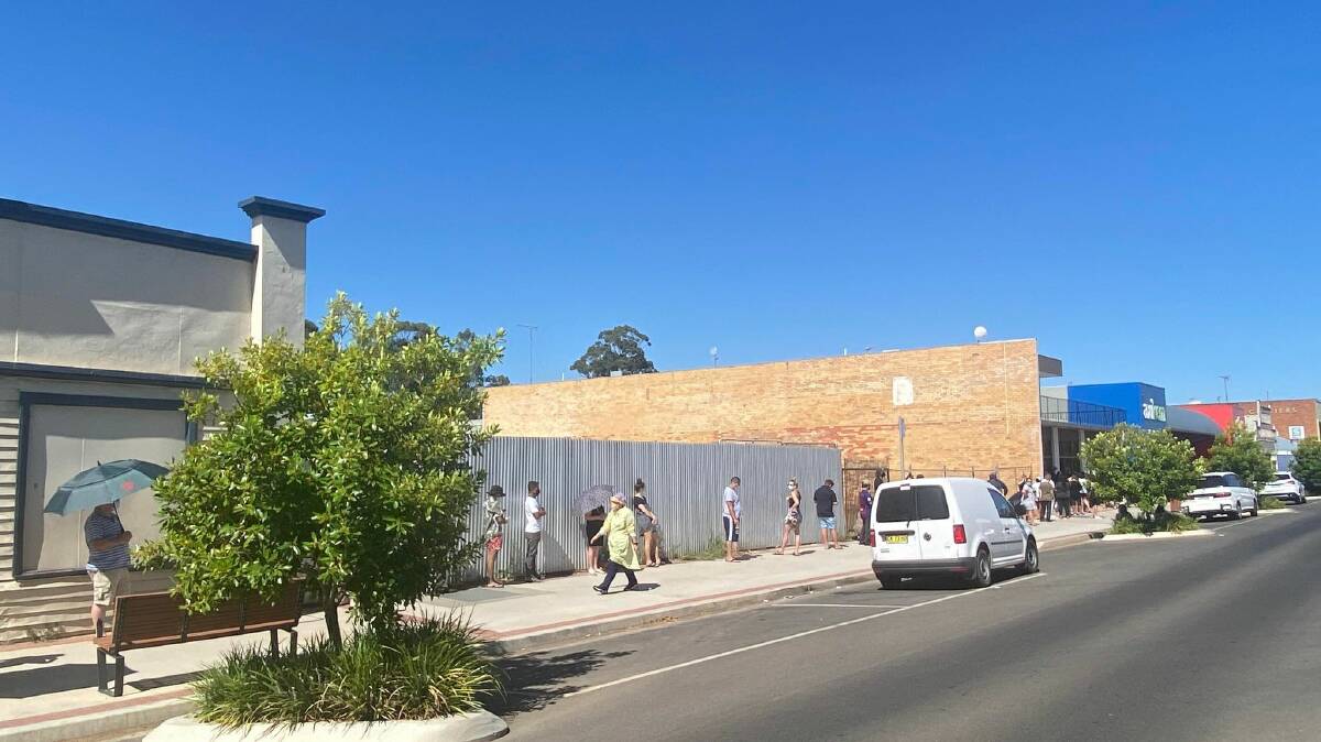 A DAY IN THE SUN: Murrumbidgee locals queue outside the Yambil Street COVID-19 testing clinic in Griffith, preparing for an arduous wait in the heat. PHOTO: Lizzie Gracie