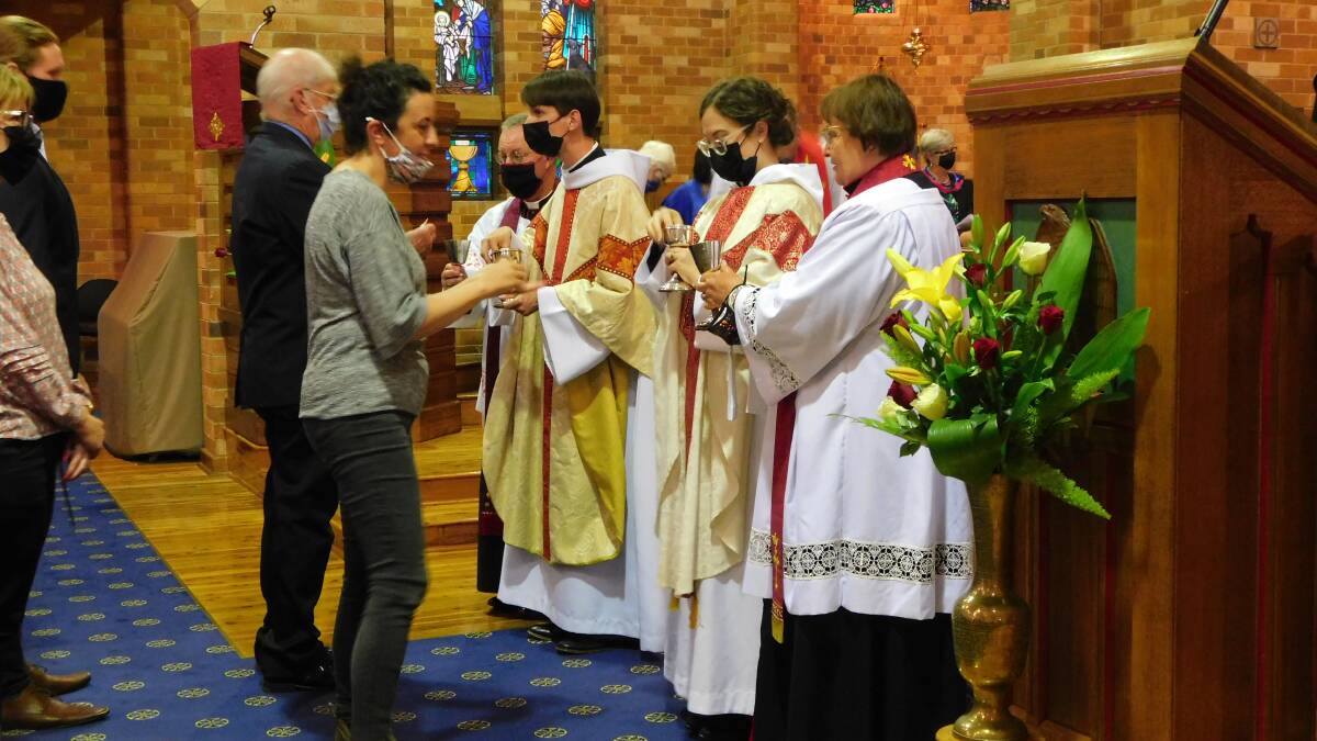 A SERIES OF FIRST: Reverends Frederik and Gemma Le Mesurier distribute communion for the first time as ordained priests within the Anglican Church. PHOTO: Supplied