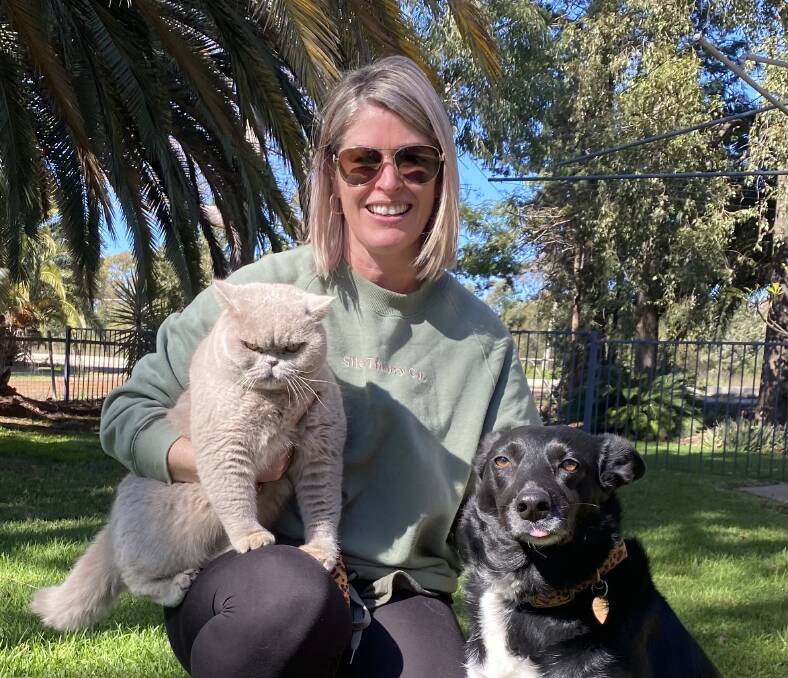 FURRY FRIENDS: Friends of Griffith Pound member Rachel Carlon with her pets Little Puddy and Jess are encouraging other pet owners to get their pets desexed.
PHOTO: Contributed 