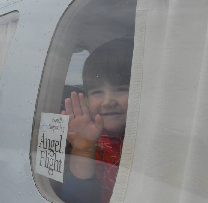 GOING HOME: Memphis Francis, 3, waves goodbye to his grandparents Mark and Alex Facer onboard his Angel Flight to Queensland on Friday morning. PHOTO: Cai Holroyd