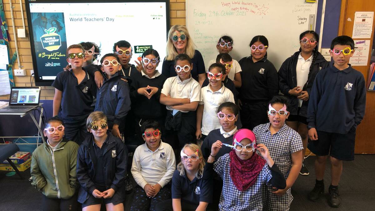 ALL SMILES: Students of Griffith PS wear sunglasses to look towards a brighter future as they celebrate their teacher Tracy Carbone. PHOTO: Supplied