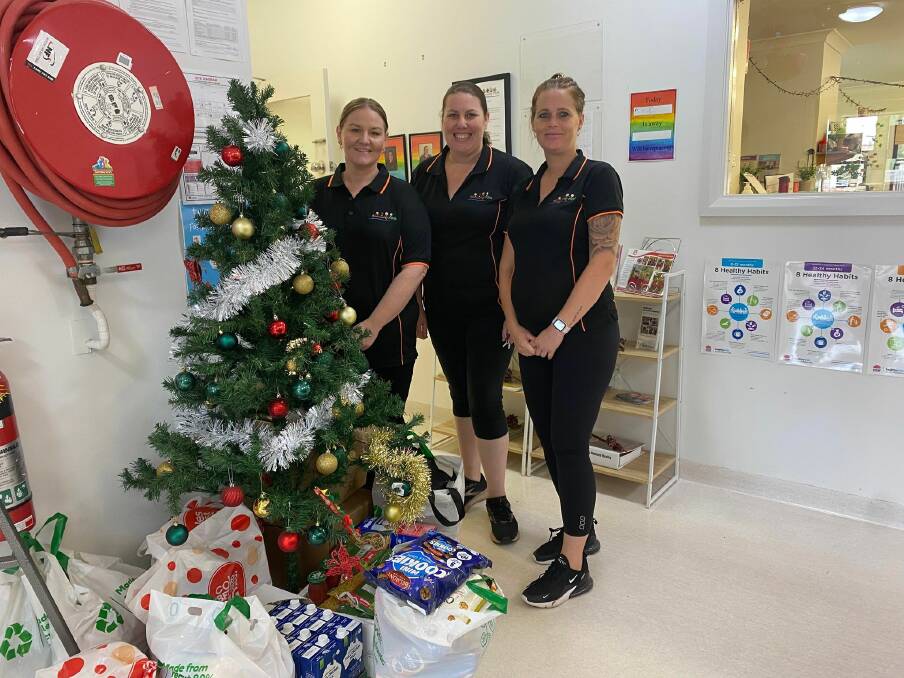 OPEN FOR DONATIONS: Nichole McCarthy, Kristy Piper and Katrina Elvy stand next to the giving tree at Community Kids Griffith were donations have been made for families at Ronald McDonald House Canberra. PHOTO: Lizzie Gracie