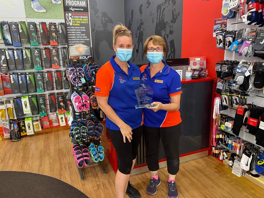 WINNERS ARE GRINNERS: Store franchisee Glennis Damini and colleague Angela Foscarini proudly show of their customer service award instore. PHOTO: Lizzie Gracie