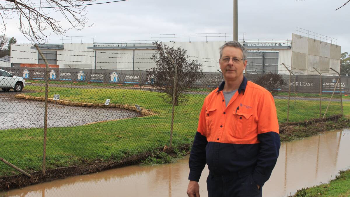 FLOOD AND SWEAT: South Pacific Seeds' Jonathan Gaisford says Council needs to update Willandra Ave residents and workers on drainage system upgrades. PHOTO: Vincent Dwyer