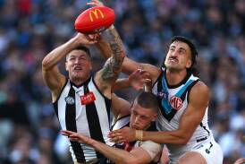 Jack Crisp, of the Magpies, marks in front of Port Adelaide's Ivan Soldo during their MCG clash on Saturday. Picture by Quinn Rooney/Getty Images