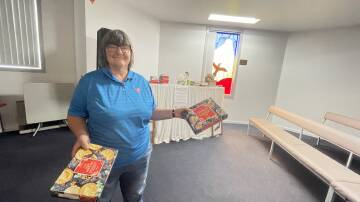 Griffith Salvation Army Major Lyn Cathcart pictured in the worship centre on Binya Street where the lunch will be held on Christmas Day. She is pictured with some of the food items that have already been donated for the cause. Picture by Allan Wilson