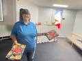 Griffith Salvation Army Major Lyn Cathcart pictured in the worship centre on Binya Street where the lunch will be held on Christmas Day. She is pictured with some of the food items that have already been donated for the cause. Picture by Allan Wilson