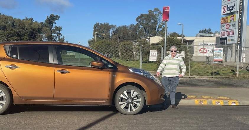 Griffith's Dr Elizabeth Dodd is critical of one proposed location for fast charging stations on Yambil Street. She is pictured with her own electric vehicle, a Nissan Leaf, at the location near Griffith Central. Picture by Allan Wilson