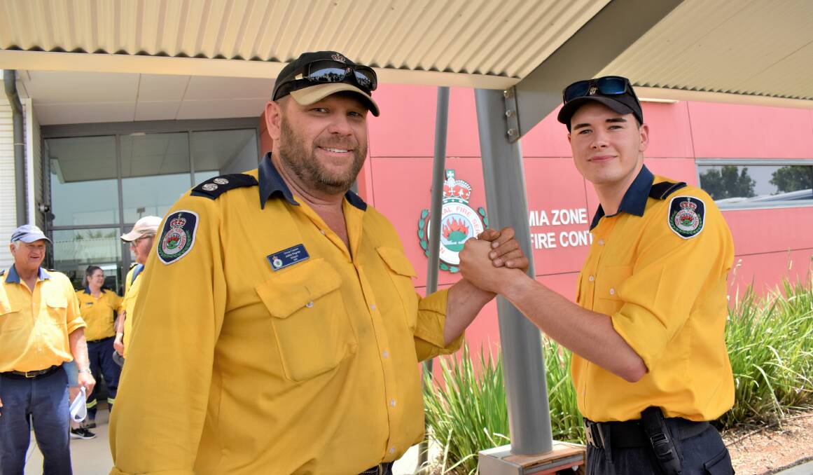PASSING THE BATON: Widgelli brigade group captain John Payne returns from Tumut, tagging in Hanwood Rural Fire Service firefighter Nathan Gough, who will come back to Griffith on Saturday. PHOTO: Kenji Sato