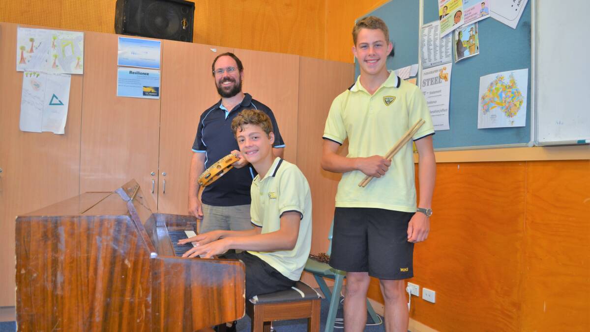 BAND TOGETHER: Music teacher Rhys Thomas, Leo Forner, and Matthew Hutchinson are rehearsing hard for their overseas trip. Picture: Kenji Sato