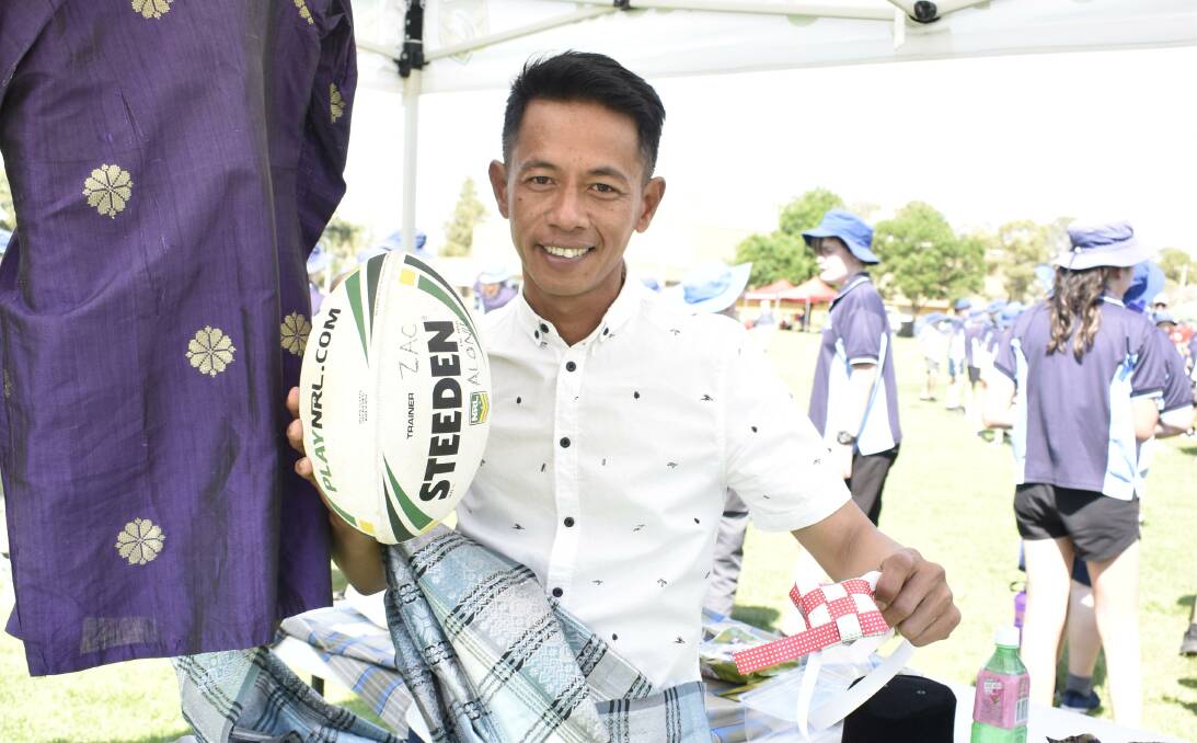 BAGUS: Suwadey Basiran teaches students all about Malaysian food, geography, and culture at the NRL cultural day at the West End Oval. PHOTO: Kenji Sato