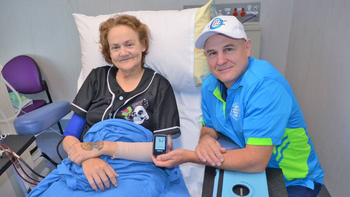 LIFESAVER: Maureen Ritchie and David Mecham test out the cutting edge Continuous Glucose Monitoring machine. Picture: Kenji Sato