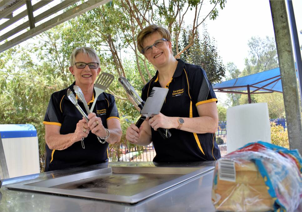 SLAPPING SAUSAGES: Soroptimists Will Mead and Louise Miller say overseas workers are an integral part of the Griffith economy, which is why they want to make them feel right at home. PHOTO: Kenji Sato