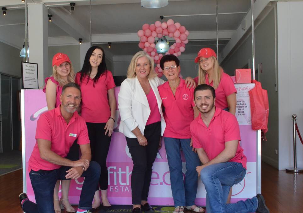 PRETTY IN PINK: Tracy Bevan (centre) with Mel Toscan (back, left), Ebony Howard, Tracy Beven, Margaret Moore, Maddi Joyce, Tony Santolin (front, left) and Jamie Bertolin at Griffith Real Estate.