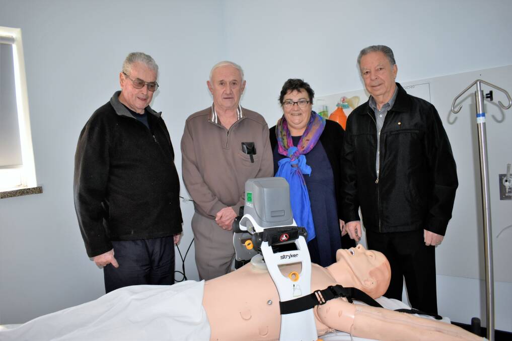 LIFE SAVERS: Griffith Heart Support Group members Graham Young, Harry Moses, Mary Fuller, and Sam Catanzariti with the Lucas 3 Compression System, which is the only one of its kind in regional NSW. PHOTO: Kenji Sato