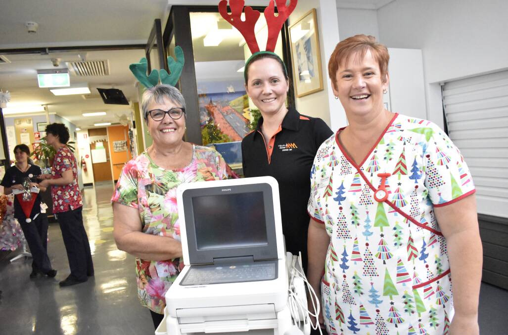 FOR THE KIDS: Bruna Ross, Mandy Page, Tracey Costin, and the ECG machine bought through last year's Give Me 5 For Kids fundraiser. PHOTO: Kenji Sato