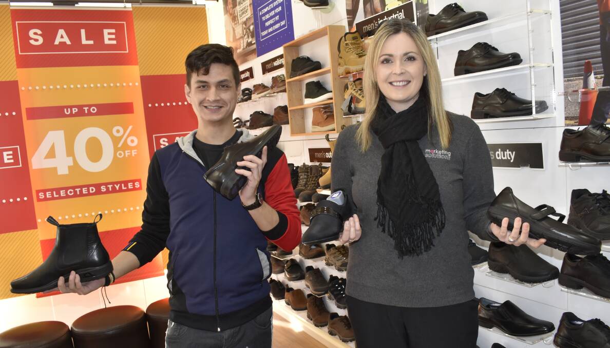 BIG SHOES: Athlete's Foot manager James "Jimmy" Alexander and Griffith Business Chamber secretary Amanda Quarisa are hyped for this year's awards. PHOTO: Kenji Sato
