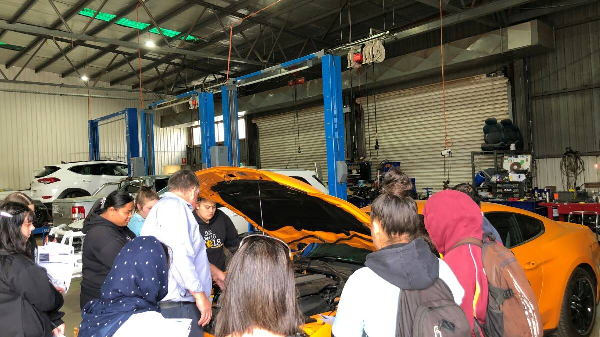 Students get revved up during car dealership industry tour
