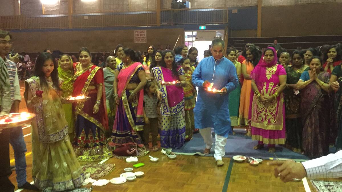 Griffith's Indian community take part in the Laxmi Puja prayer during the Diwali celebrations on Saturday.