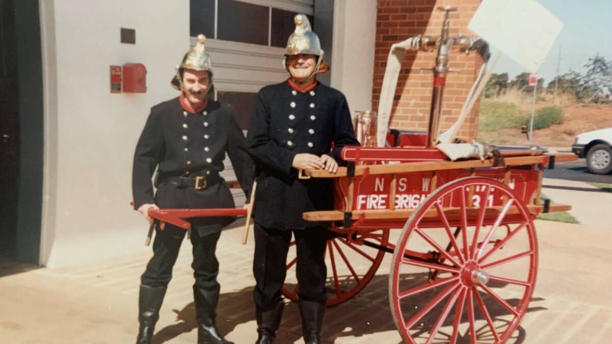 Charlie Bishop with a vintage fire cart he restored and showed off in various parades.
