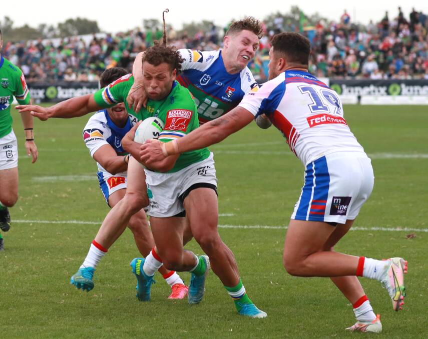 COMING BACK: Canberra centre Sebastian Kris tries to break a Newcastle tackle during this year's NRL clash in Wagga. Picture: Les Smith
