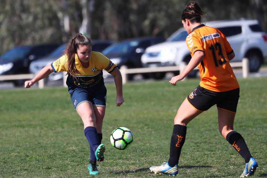 BACK IN FINALS: Junee's Abby Foley takes on a Wagga United defender during the first week of Leonard Cup finals last year. Picture: Emma Hillier