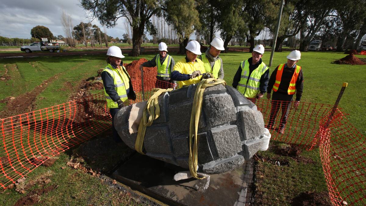 NEW HOME: Volunteers help move the scultpures into IOOF Park. Picture: Anthony Stipo.