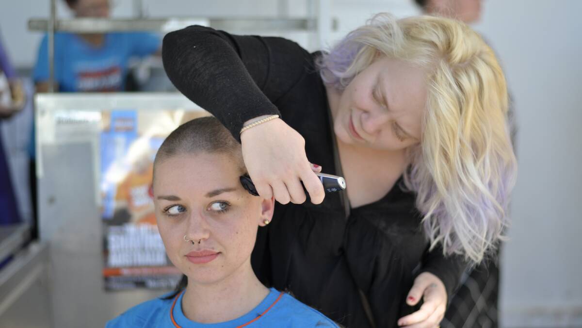 STELLAR EFFORT:  Makeria Wood shaves Jacinta O'Flaherty's head on Friday as the young woman raised money in support of the Leukaemia Foundation.