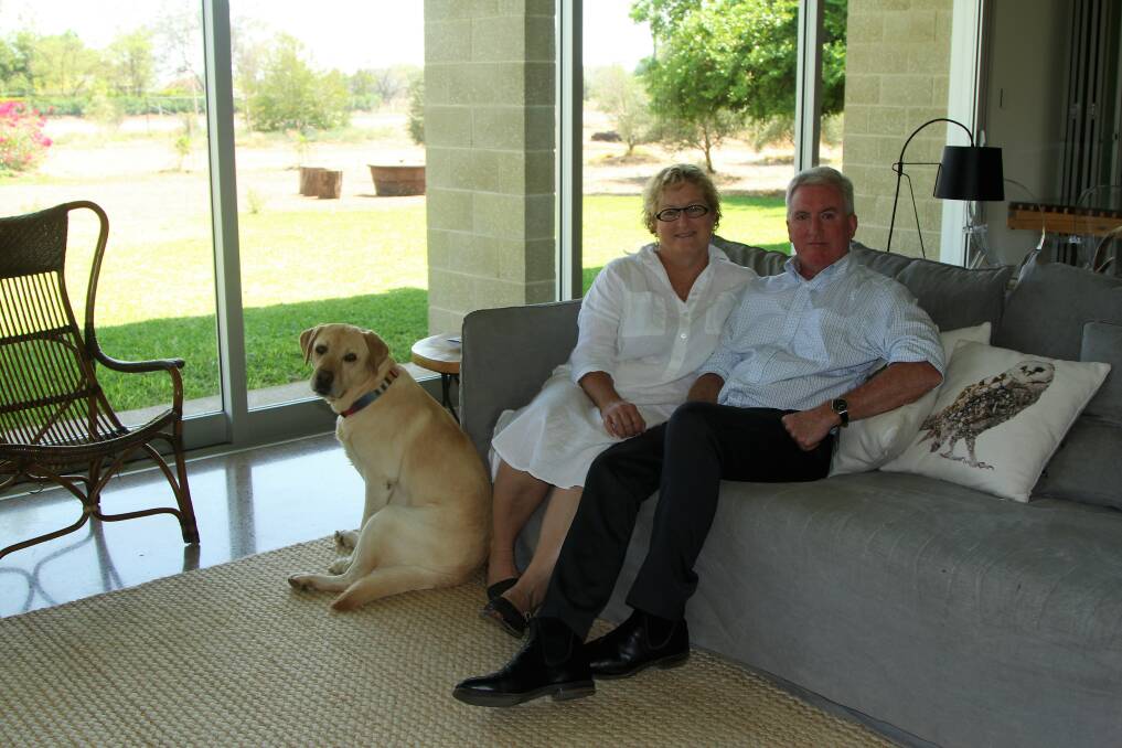 Mary-Ann and Bill Ringrose, plus the family pet Lardy, taking in the garden view from the open plan kitchen/dining/lounge area.