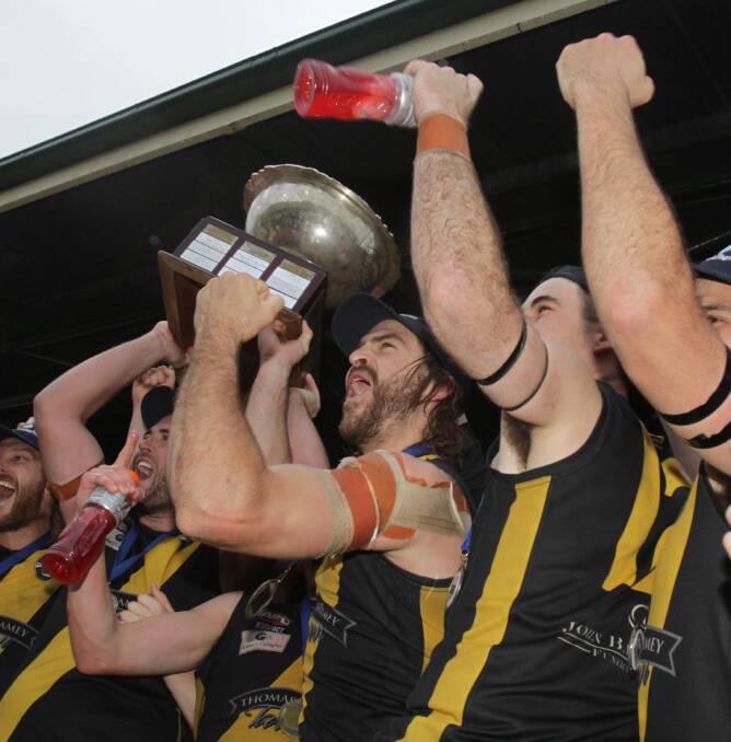 Shaun Campbell lifts the premiership cup aloft in September last year.