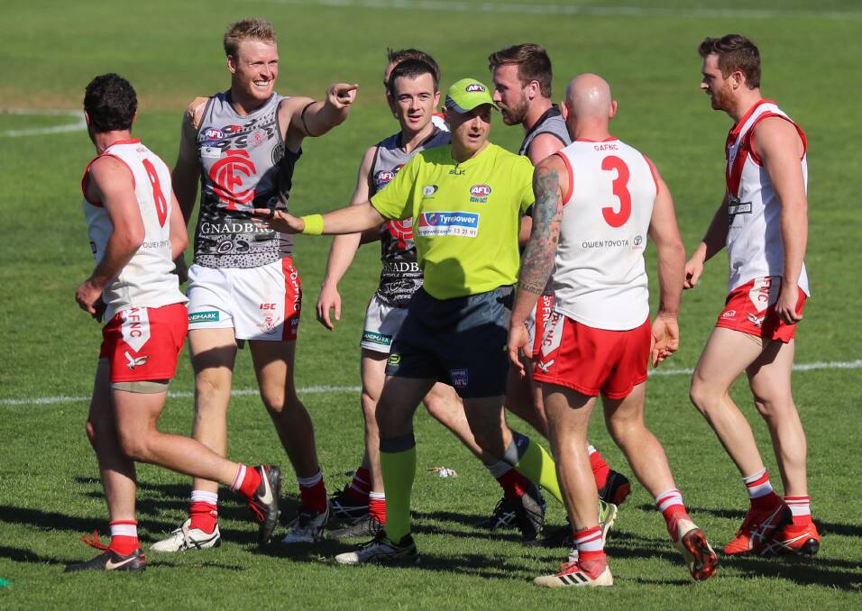 Collingullie-GP players get into Griffith defender Guy Orton during the second quarter of Saturday's grand final. Picture: Les Smith