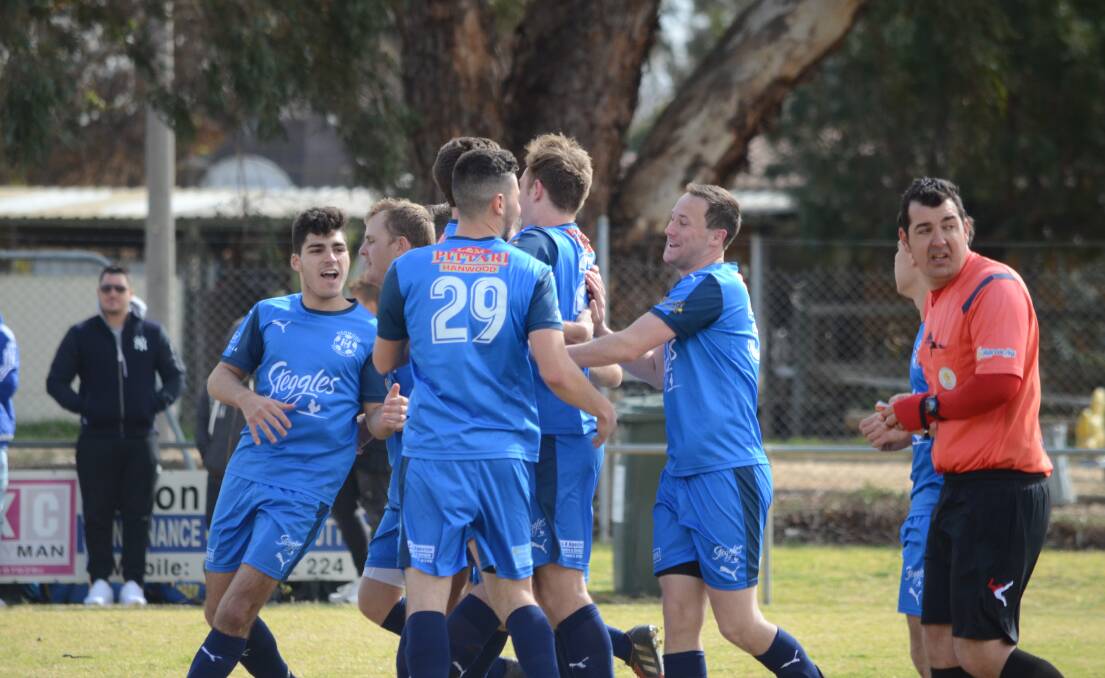 DECISION TIME: Hanwood celebrate a goal in the Griffith competition last season. 