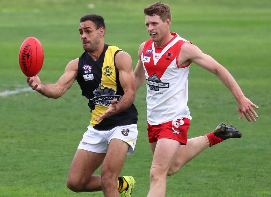 UNDER REVIEW: Jesse Manton and James Toscan compete in the Riverina League grand final last month. Both Wagga Tigers and Griffith will have their spending reviewed by AFL NSW-ACT.
