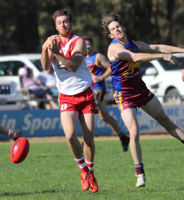 NEAR MISS: Griffith's Heath Northey and Ganmain-Grong Grong-Matong's Mick Daniher contest for the ball at Ganmain Sportsground on Sunday. Pictures: Les Smith