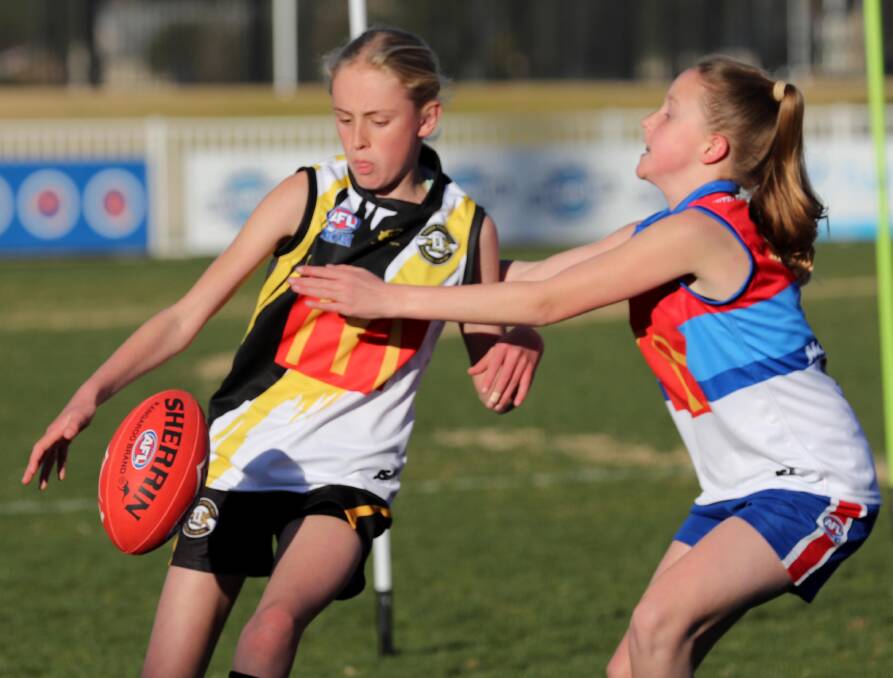 GROWTH AREA: Wagga Tigers' Harriet Priest and Turvey Park's Maggie Hallcroft in action during the AFL Youth Girls competition in Wagga this year. Picture: Les Smith