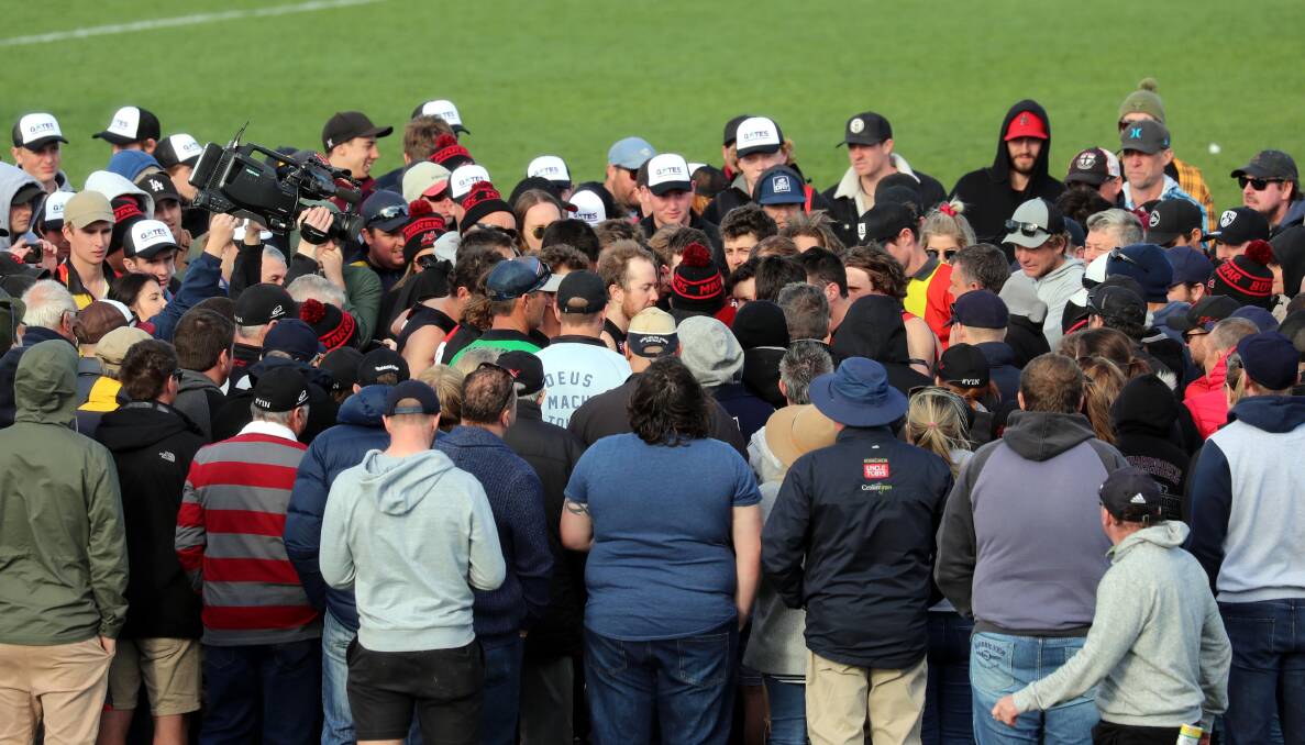 FAN FAVOURITE: A big crowd huddles around Marrar coach Shane Lenon at his three-quarter-time address during this year's Farrer League grand final at Robertson Oval. Picture: Les Smith