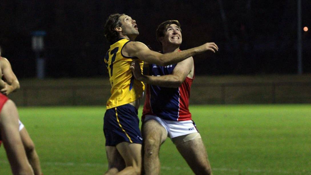 ON AGAIN: Riverina's Ben Walsh and Canberra's James McCabe compete in the interleague game at Football Park in Canberra on Saturday night. Picture: Matt Olsen