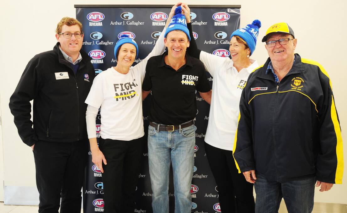 ALL SMILES: AFL Riverina chairman Michael Irons, Julie Cornell, Chris Daniher, Dorothy Vearing and Hume League official Barry Malone at the 'Sock it to MND' launch. 