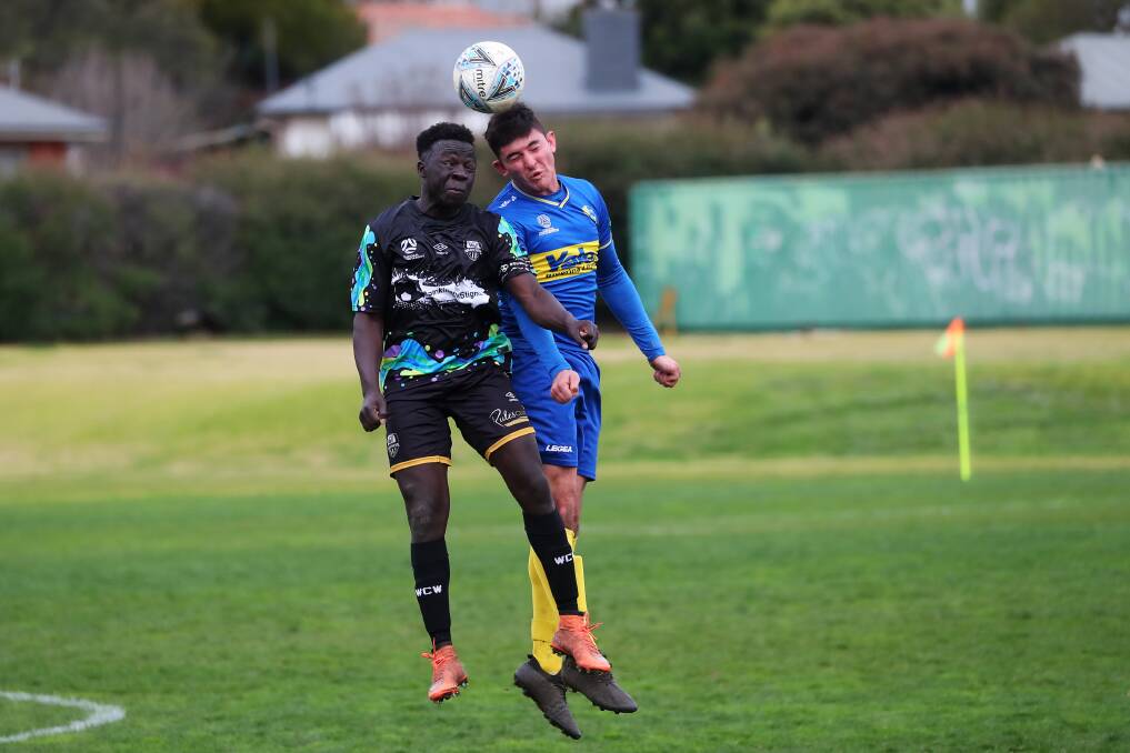 HEAD TO HEAD: Wagga City Wanderers' Jacob Ochieng and Yoogali SC's Samuel Raciti battle it out at Gissing Oval on Saturday. PHOTO: Emma Hillier