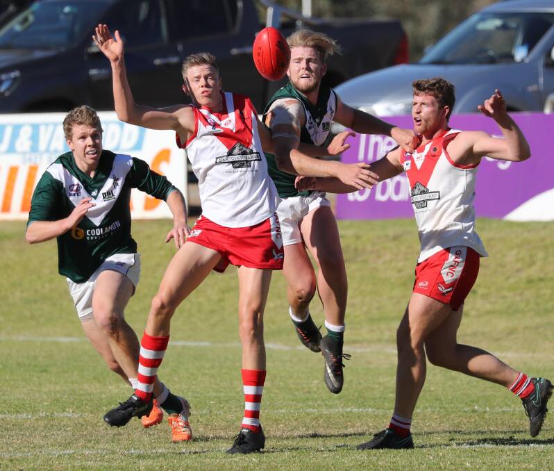 UP FOR GRABS: Joe Redfern, Riley Irvin, Matt McGowan and James Toscan compete during Coolamon and Griffith at Kindra Park. Picture: Les Smith