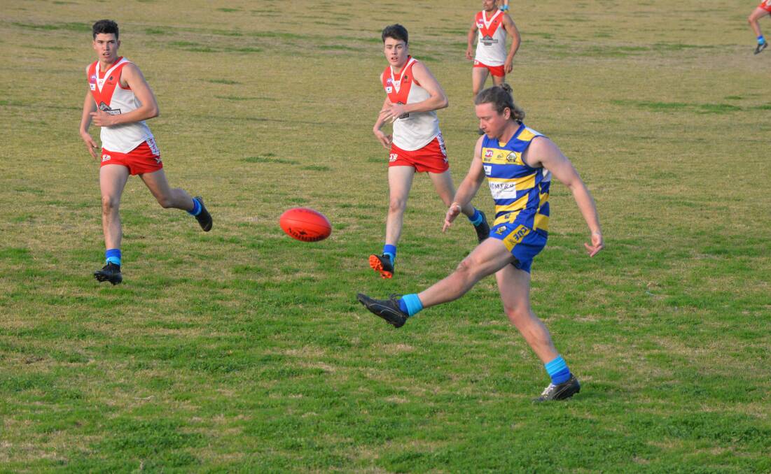 ON THE ATTACK: MCUE's Jack Collins gets his kick away during the Goannas' big win over Griffith at Mangoplah Sportsground on Saturday.