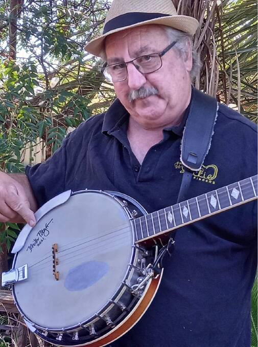 MOMENTO: Phil Gallagher from Stickie Fingers with his freshly autographed banjo from Keith Potger. PHOTO: Supplied