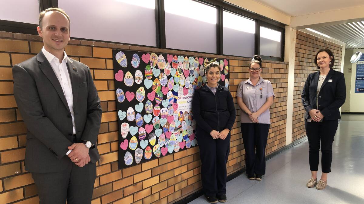 UPLIFTED: Griffith Base Hospital GM Greg Brylski with hospital staff Talia Macri, Kayla Bruton and Fiona McKern enjoying some of the sincere messages of gratitude from Year One at St Patrick's Primary School. PHOTO: Kat Vella