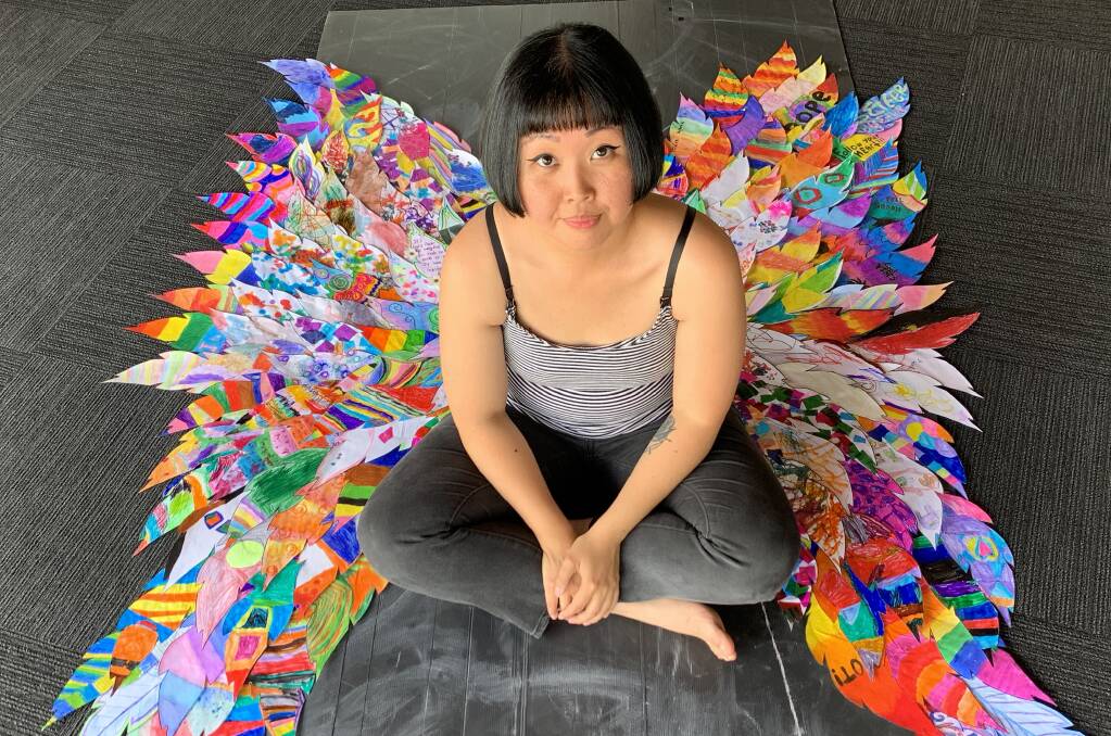 TECHNICOLOUR: Isis Ronan attaching the first submissions of 'feathers' to the wings that she hopes will reach 6-10 metres long by the end of the project. PHOTO: Shane Ronan