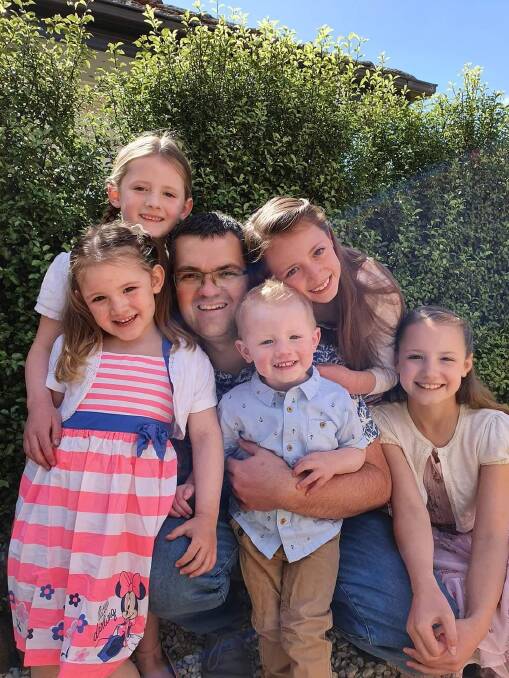 CONNECTION: Kevin Poulton (centre) with his five children. Kevin encourages all new dads to sign up for the SMS service. PHOTO: Contributed