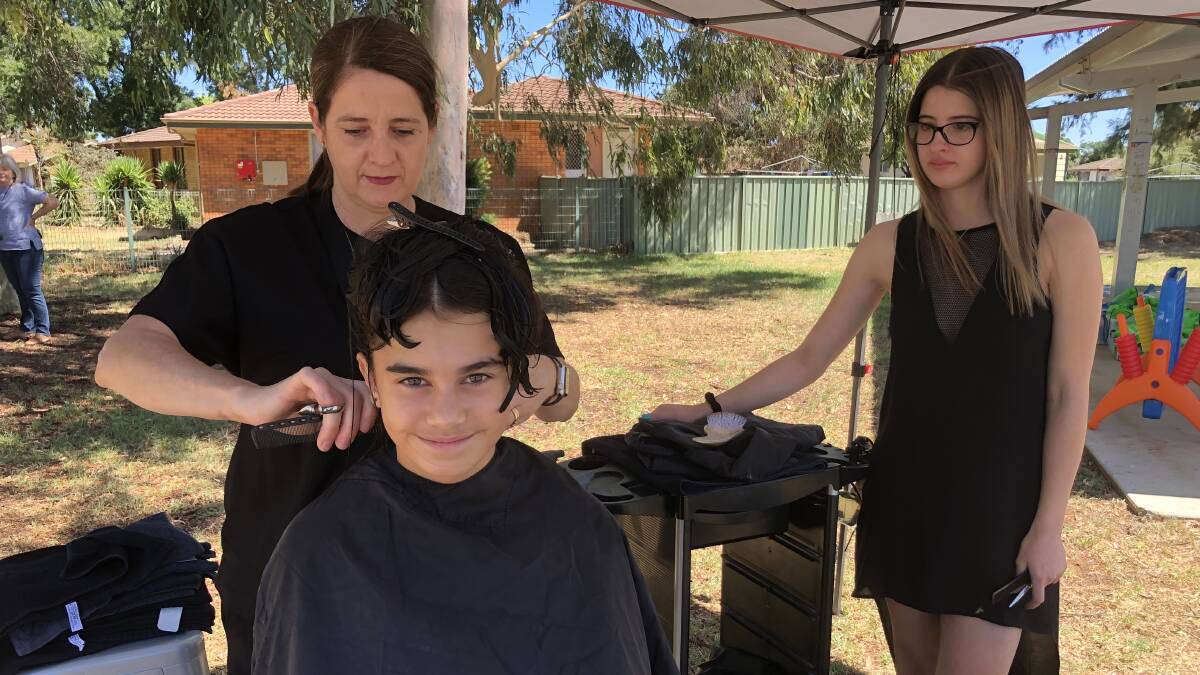 NEW SCHOOL NEW LOOK: Sherridan Skelton having her 'back-to-school-cut' in preparation for her first day at high school next week. Natalie Donadel (left) and Sienna Donadel (right). PHOTO: Kat Vella