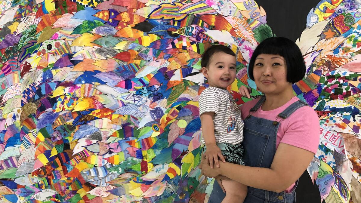 COLOURS OF THE WORLD: Griffith creator and artist Isis Ronan with her son Dylan at the Uplift Griffith wing installation at Griffith Central. PHOTO: Kat Vella