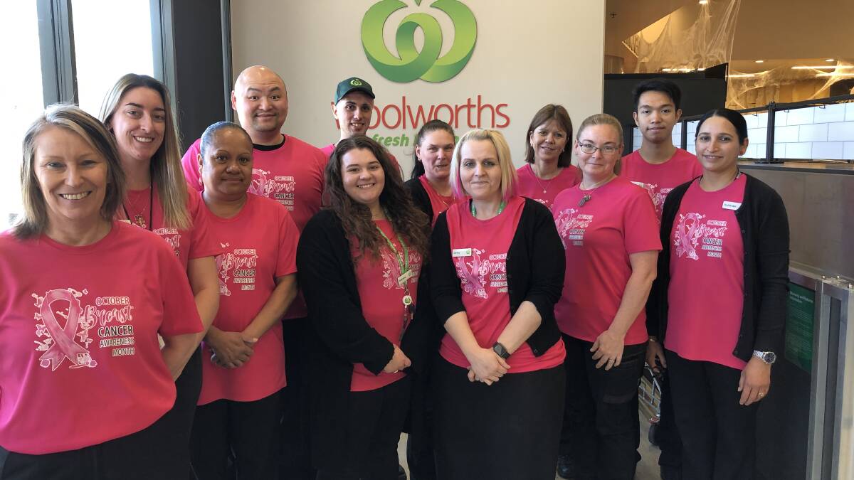 HUMBLED: Store Manager Jenny Worthington (centre) and some of her North Griffith Woolworths team in their Pink Up Griffith shirts for October. PHOTO: Kat Vella