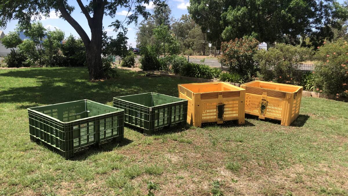 BARE ESSENTIALS: Orange crates that will form the first of the garden beds at the Community Centre. PHOTO: Kat Vella