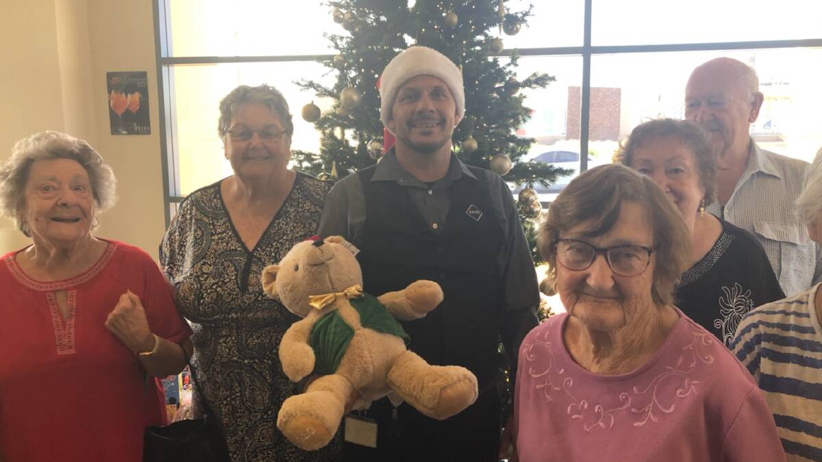 GRATEFUL: Brad Charles with generous members of the Griffith Aged Support Service's Tuesday lunch group who contributed for the toy run. PHOTO: Contributed